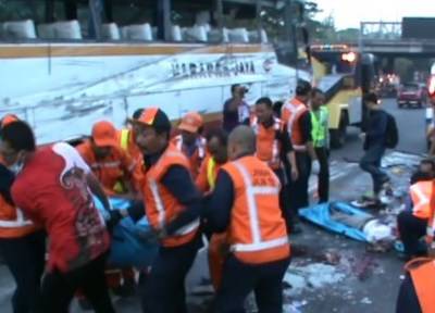 EVAKUASI - Sejumlah petugas mengevakuasi korban bus Harapan Jaya yang terguling di jalan Raya Bungurasih, Waru, Sidoarjo, Senin (13/10/2014). foto istimewa

