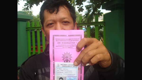 Orang tua siswa menunjukkan bukti nomor ujian dan kartu pembayaran SPP. foto: soewandito/ BANGSAONLINE