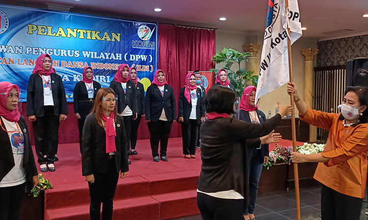 Ketua Umum DPP Ikatan Langkah Dansa Indonesia (ILDI) Ambar Susilastuti (kanan) saat menyerahkan bendera pataka kepada Ketua DPW ILDI Kota Kediri Masa Bhakti 2021-2025 Maria Dominica Kasiatun, S.E. (foto: MUJI HARJITA/ BANGSAONLINE)