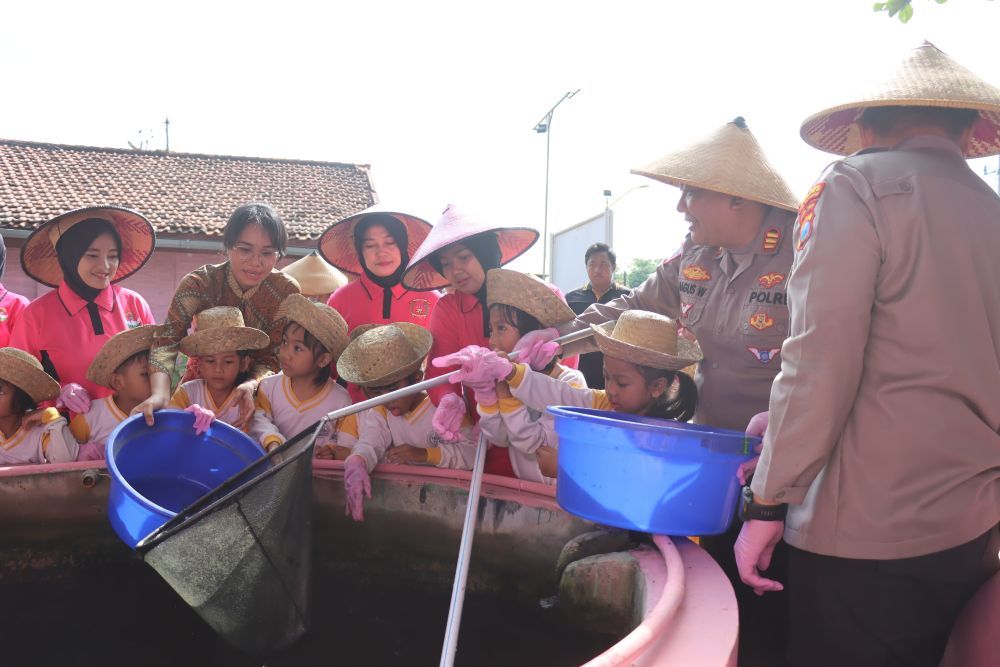 Kapolres Pamekasan AKBP Hendra Eko Triyulianto bersama Ketua Bhayangkari Cabang Pamekasan saat memanen ikan lele.