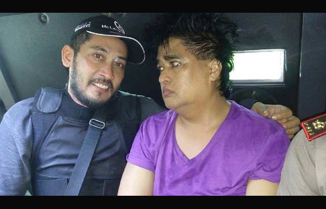 Taat Pribadi (baju ungu) saat dibawa dengan menggunakan mobil aparat untuk diamankan ke Polda Jatim.