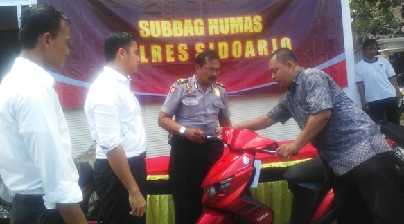 Kasubag Humas Polres Sidoarjo AKP Samsul Hadi dan Kasat Reskrim Polres Sidoarjo AKP Ayub Diponegoro Azhar didampinggi Kanit Pidum Polres Sidoarjo Ipda Hafidz Dian Maulida mnyerahkan BB sepeda motor ke pemiliknya, kemarin. foto : nanang ichwan/BangsaOnline.com