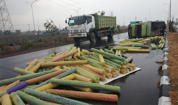 Muatan truk box berupa kain polyester berserakan di jalan arteri Porong.