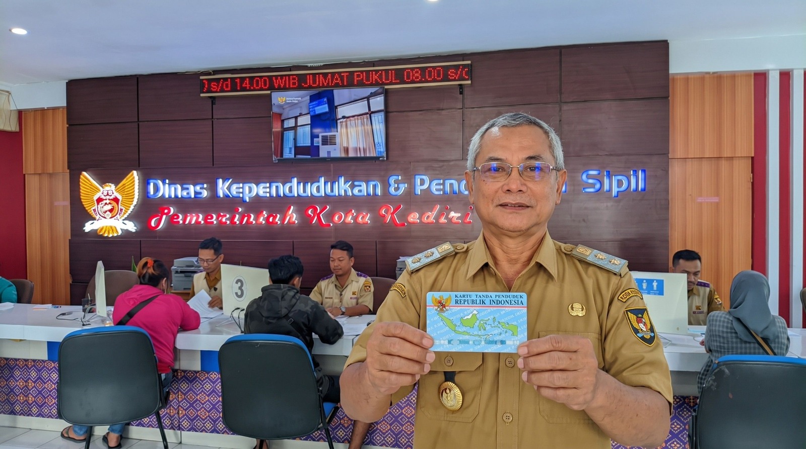 Kepala Dispendukcapil Kota Kediri, Marsudi Nugroho saat memegang e-KTP. (Ist).