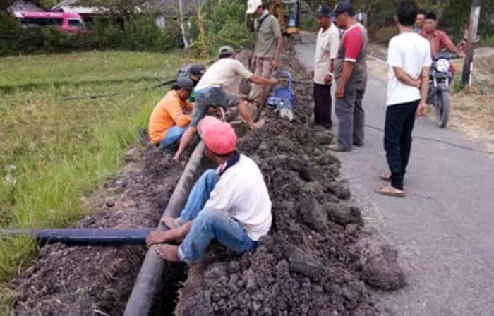 Proses pemasangan pipa jaringan distribusi tersier di Desa Kemantrenrejo.